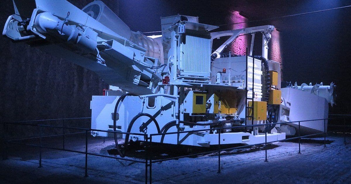 A continuous miner on display under coloured lights in the Bad Friedrichshall visitor salt mine in Germany