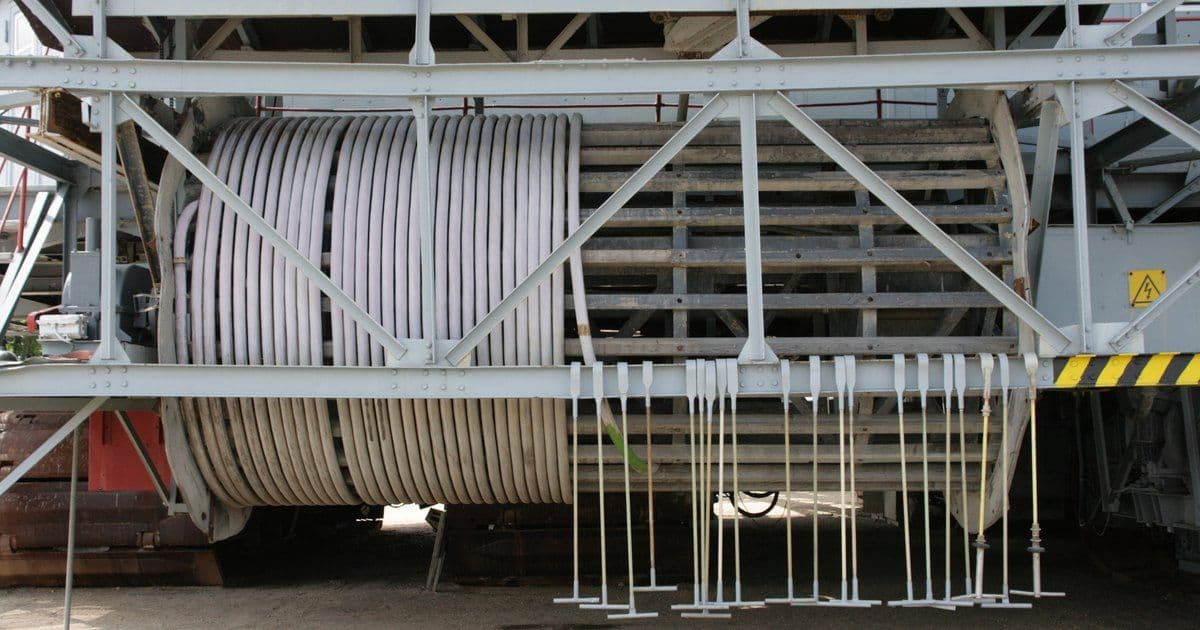 A wide cable drum on a preserved bucket-wheel excavator, with grey cable wound in side-by-side turns across part of its width