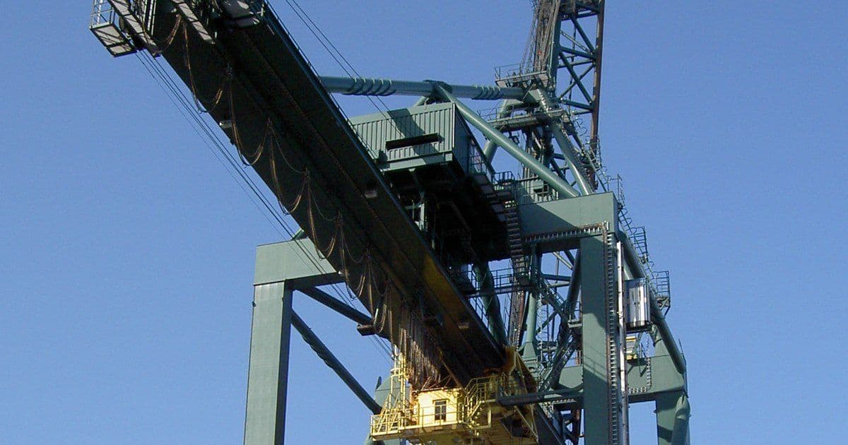 Festoon cable loops hanging along the boom of a container crane at Antwerp harbour, above the yellow trolley