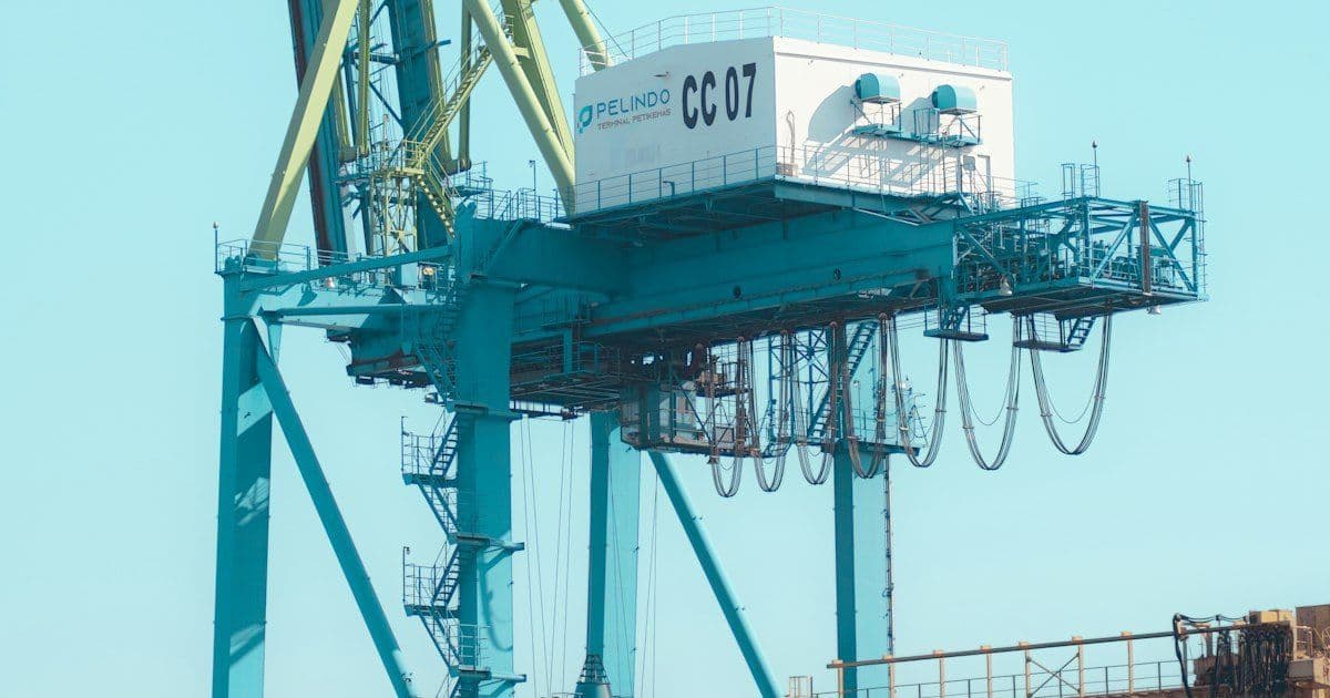 Festoon cable loops hanging under the girder of a container crane