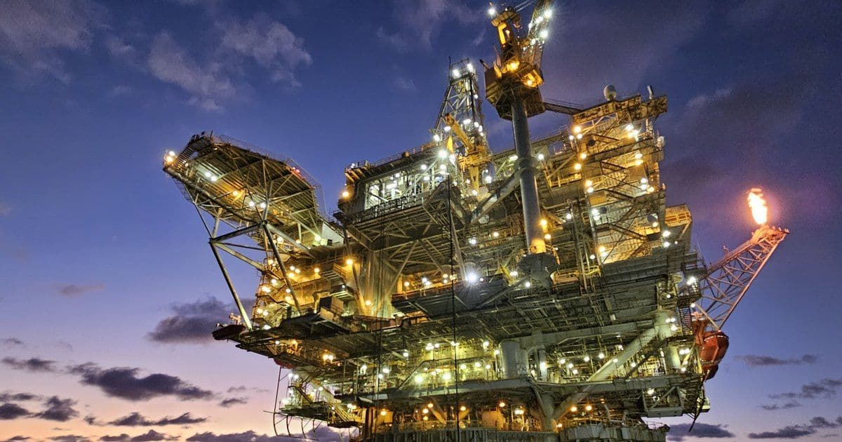 The Holstein spar platform lit at dusk in Green Canyon, Gulf of Mexico, with its flare burning