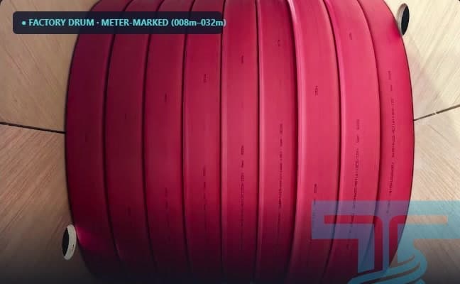 Close-up of a factory drum wound with dark-red flat cable and meter marks along its edge