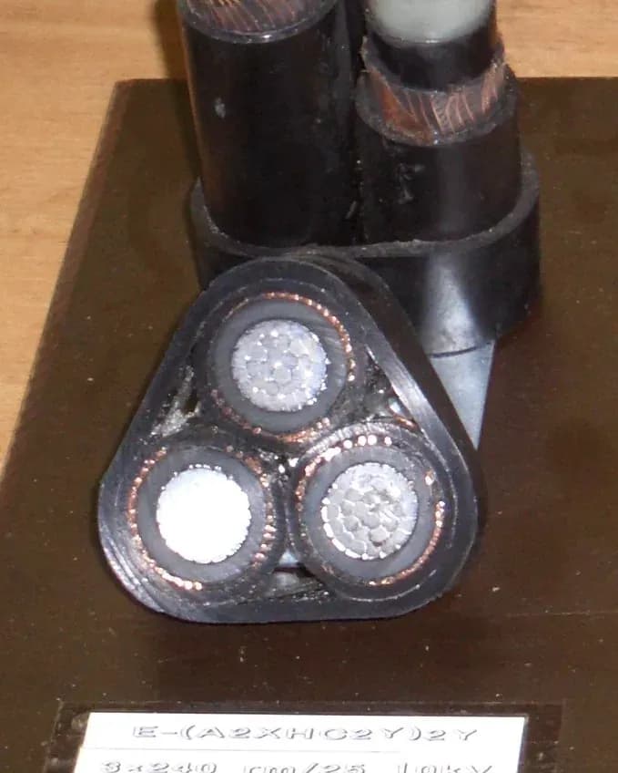 Cross-section of a three-core 10 kV cable sample with a ring of copper wires around each insulated core