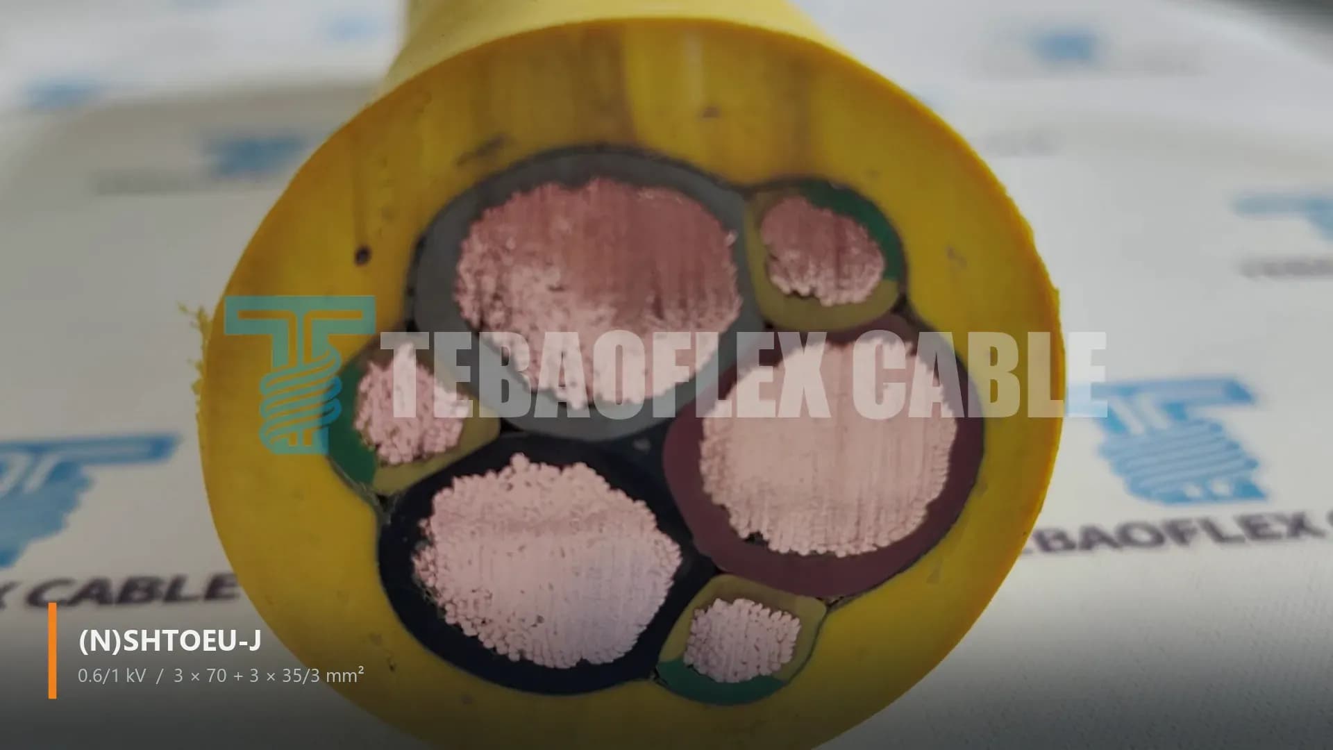 Cut end of a yellow (N)SHTÖU-J 3 × 70 + 3 × 35/3 mm² reeling cable with brown, black and grey power cores and three green-yellow earth cores