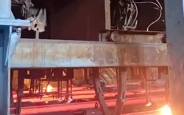 Moving oxy-cutting equipment operating above a hot steel processing line