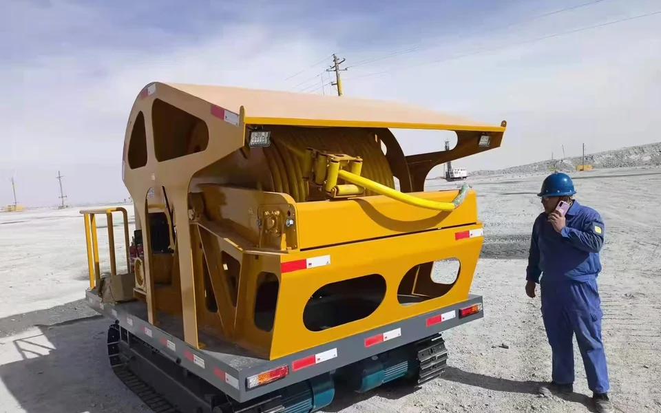 Tracked cable-reeling vehicle documented at an open-pit mining site